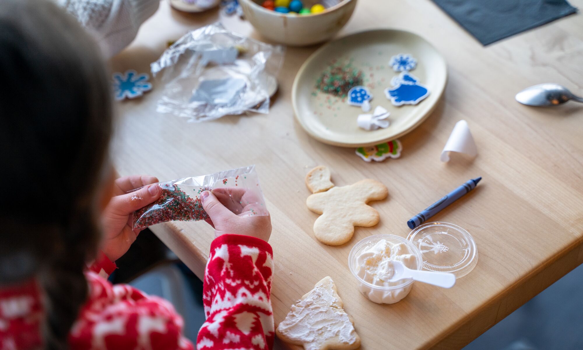 A child makes a Christmas cookie at Mountaintop Christmas in Banff National Park at the Banff Gondola.